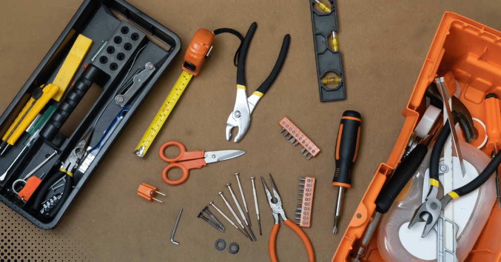 Assorted home maintenance tools neatly arranged on a surface, representing the essentials for DIY home repairs and maintenance tasks