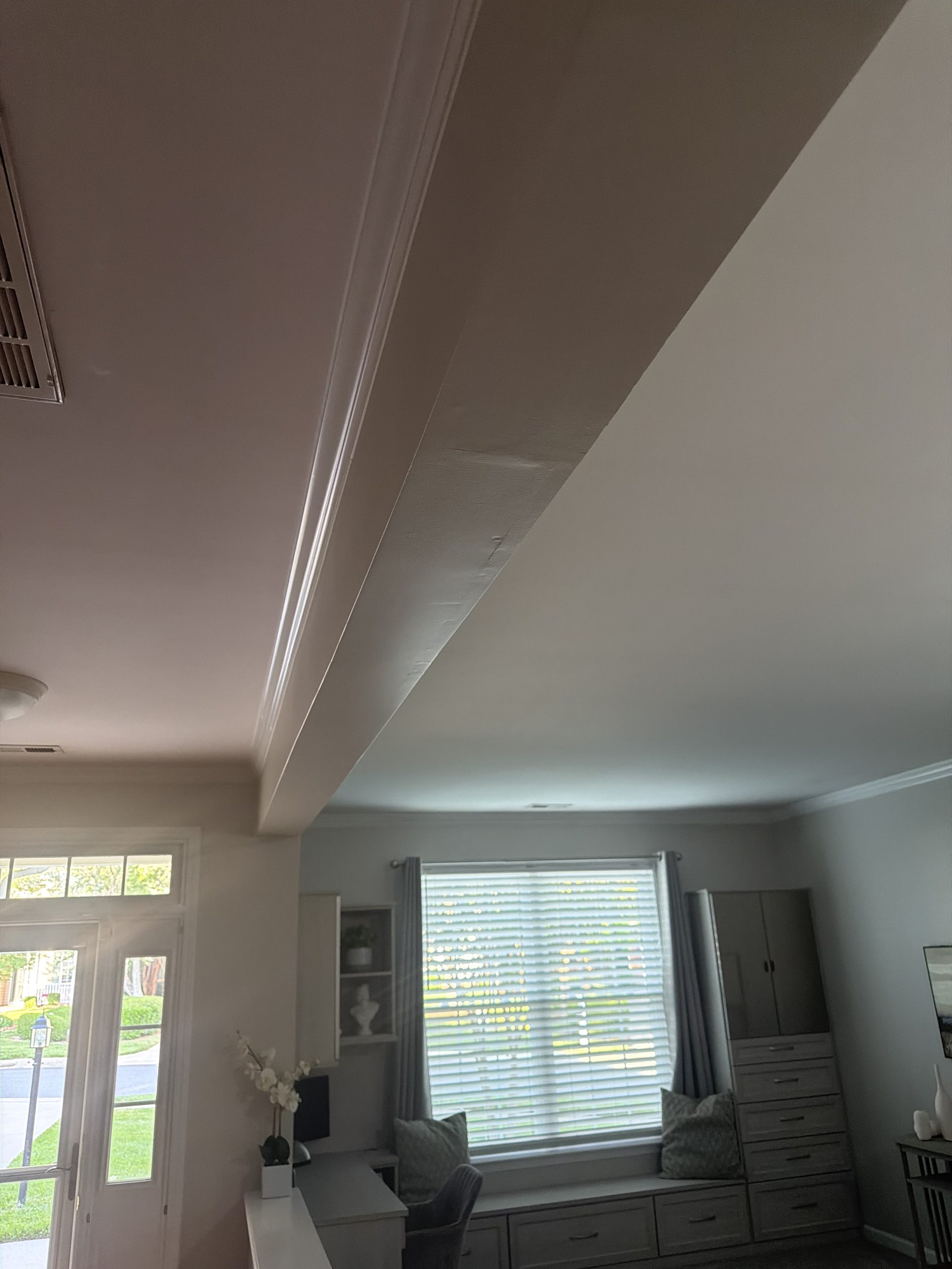 Wrapped Interior Beam with finishing imperfections. Is this a sign of a structural problem?